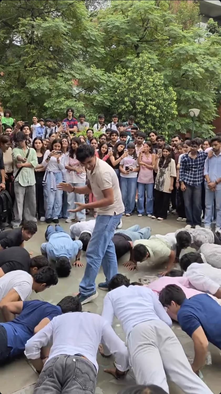 A large college crowd taking part in a FitSocial push-up challenge