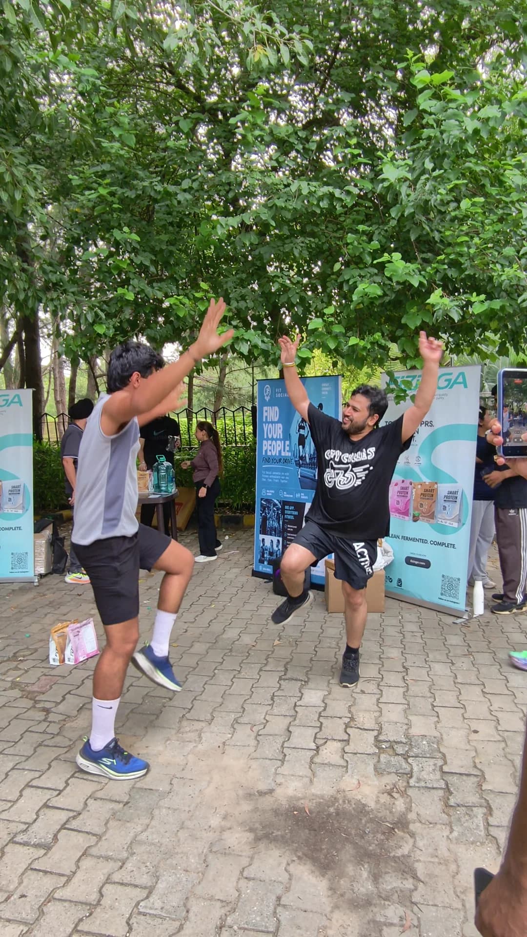 Two FitSocial community members dancing together after a group run