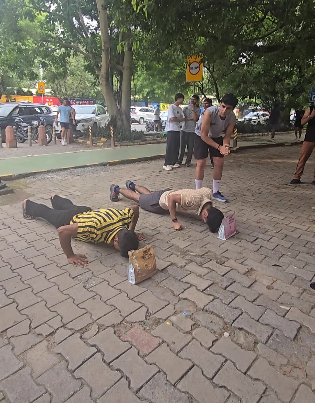 Two runners competing in a push-up challenge after a FitSocial community run