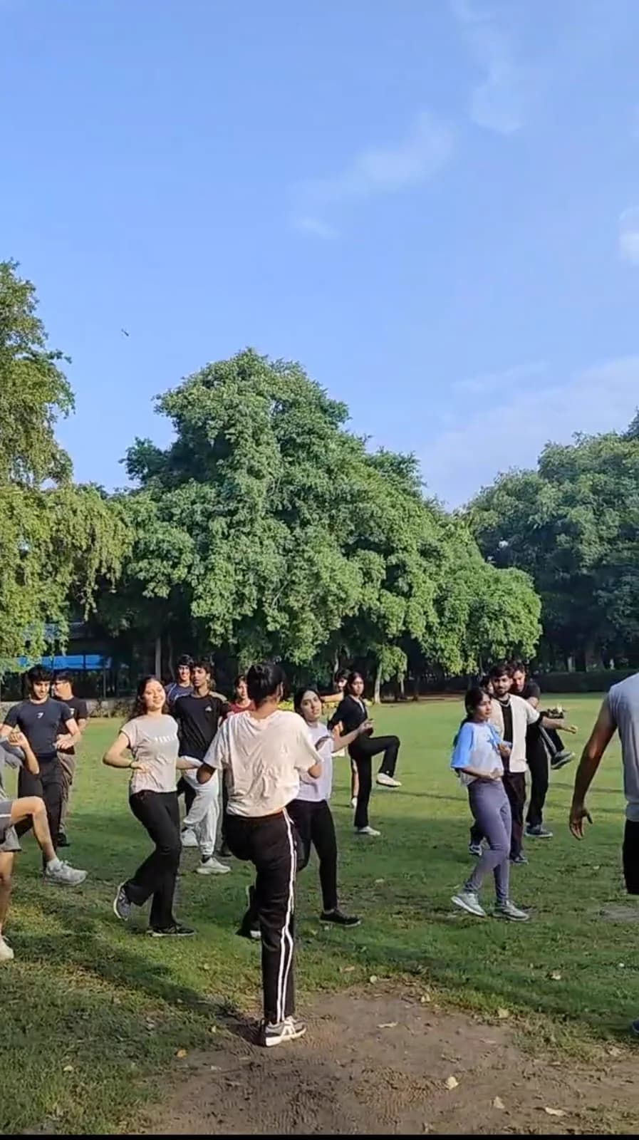 FitSocial community members dancing together during a warm-up before a run